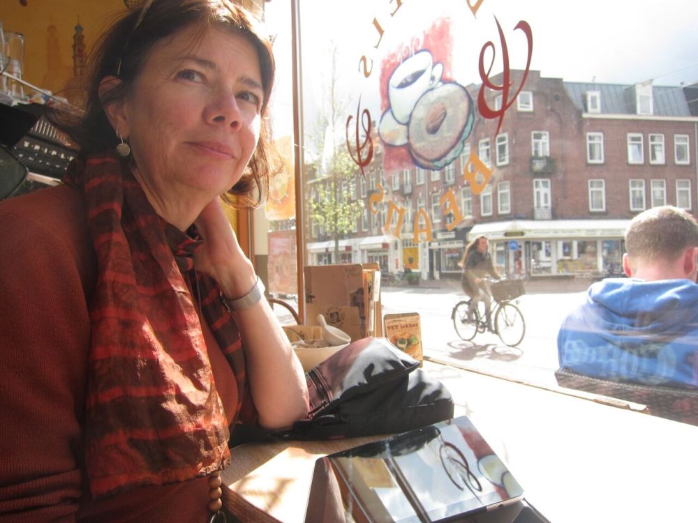 Susie in the window of a cafe, waiting for a bagel