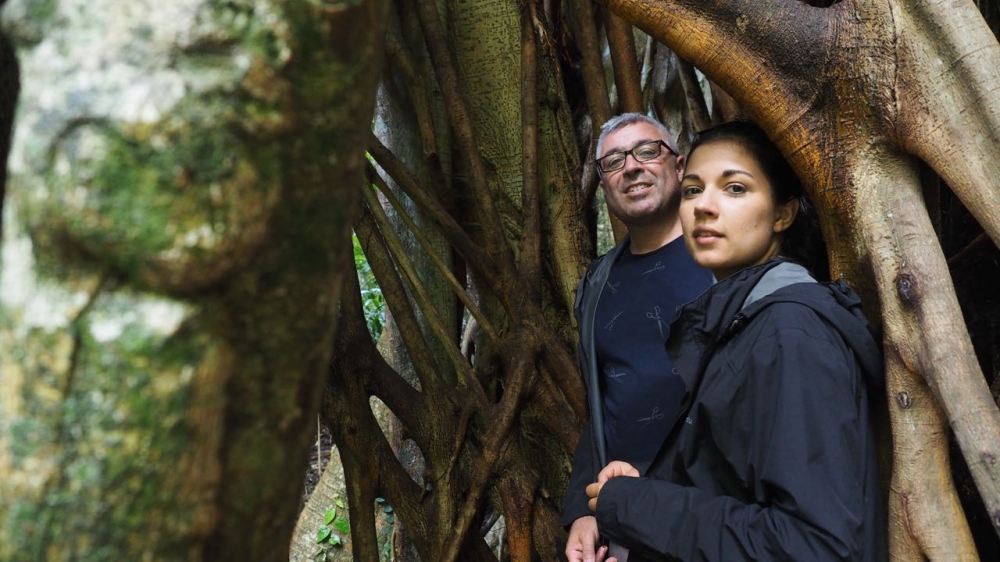 Ruby and Jordo inside the roots of a giant Strangler Fig