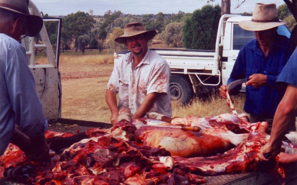 Photo of Keith cutting up a beast for dingo bait